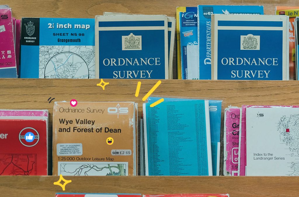 A shelf of old Ordnance Survey maps, representing local SEO. The shelf prominently features a map for the Wye Valley and Forest of Dean